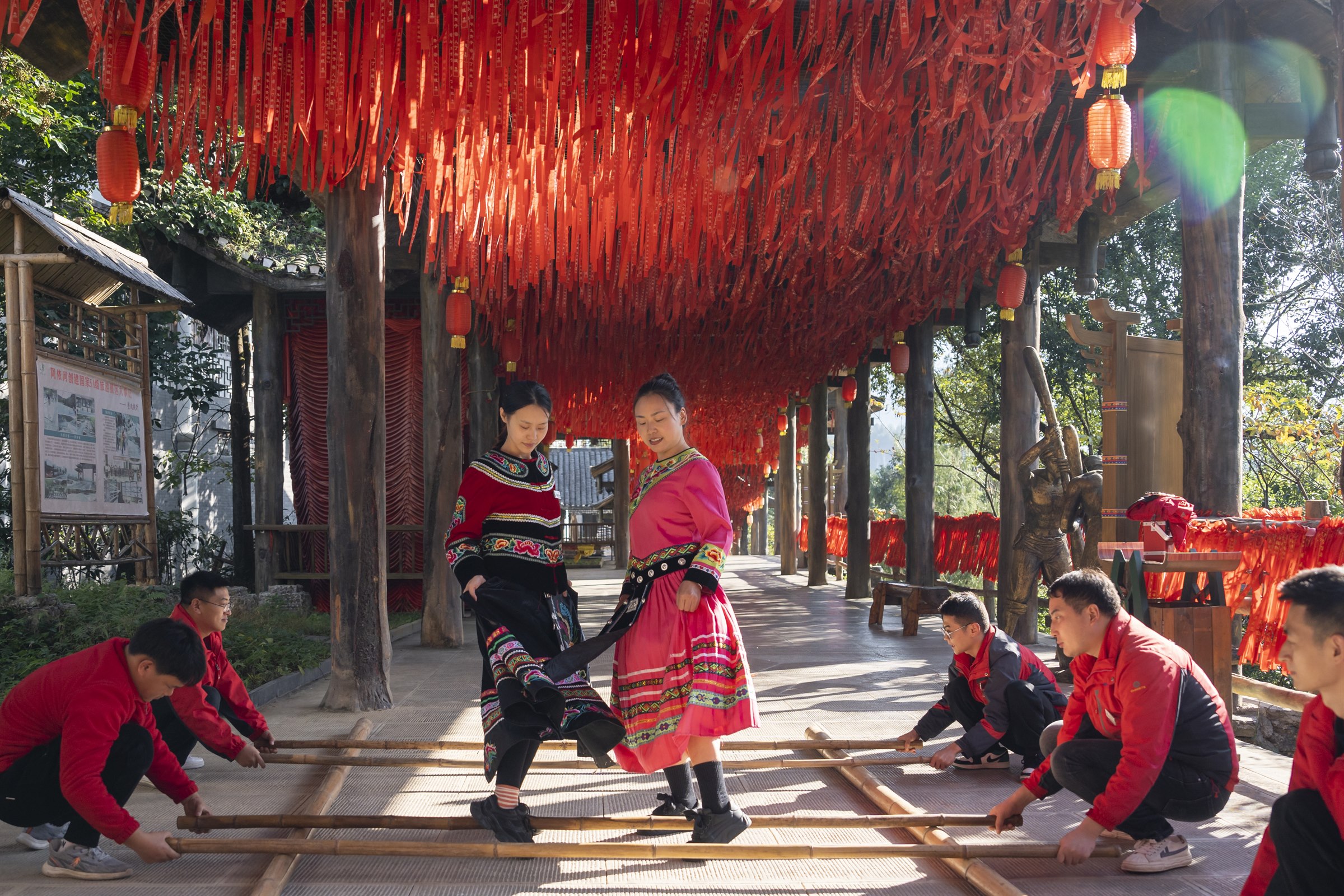 Visitors meeting local performers beside the Ayi River